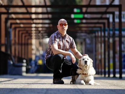 Raúl Fernández with his guide dog, close to his home in Madrid.