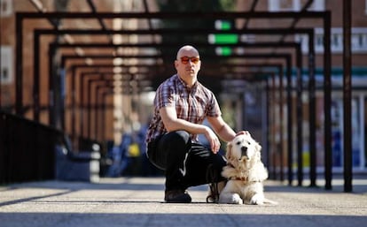 Raúl Fernández with his guide dog, close to his home in Madrid.