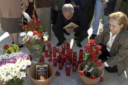 Una mujer coloca unas flores ante la fosa común del cementerio de San Eufrasio, en Jaén.