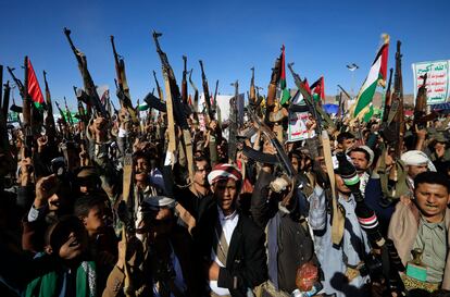 Houthi supporters shout slogans while holding up weapons during a protest against the US and Israel and in support of Palestinians, in Sana'a, Yemen, 23 February 2024.