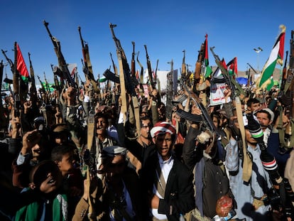 Houthi supporters shout slogans while holding up weapons during a protest against the US and Israel and in support of Palestinians, in Sana'a, Yemen, 23 February 2024.