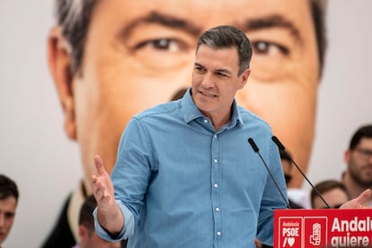 Pedro Sánchez, durante el mitin de esta mañana en Torredelcampo (Jaén). Tras él una imagen en pantalla de Juan Espadas.