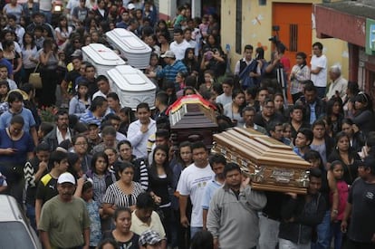A funeral for five of the victims of the mudslide.