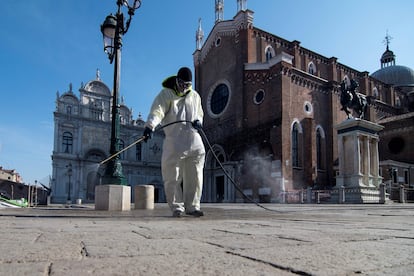 A worker disinfects Piazza San Marco in Venice.