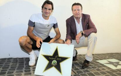 El director del torneo de Halle y Federer con la placa que reconoce al suizo como ganador de 2013. 