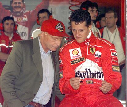 El piloto alemán Michael Schumacher (a la derecha) conversa con el excampeón Niki Lauda, durante unos entrenamientos en el circuito de Monza (Italia), en 1998.