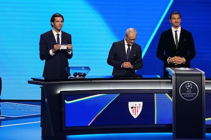 Former Brazilian player Kaka, left, displays Qarabag FK as former soccer star Zlatan Ibrahimovic, right, and UEFA Deputy General Secretary Giorgio Marchetti attend the Champions League soccer league phase draw in Monaco, Thursday, Aug. 28, 2025. (AP Photo/Laurent Cipriani)