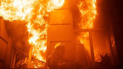 Shows rescuers extinguishing a fire in an administrative building in Odesa