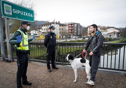 Police stopping a man from crossing the border between Spain and France on Tuesday.