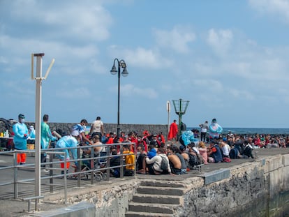 Decenas de inmigrantes son atendidos en el muelle tras llegar a Órzola (Lanzarote), este domingo.