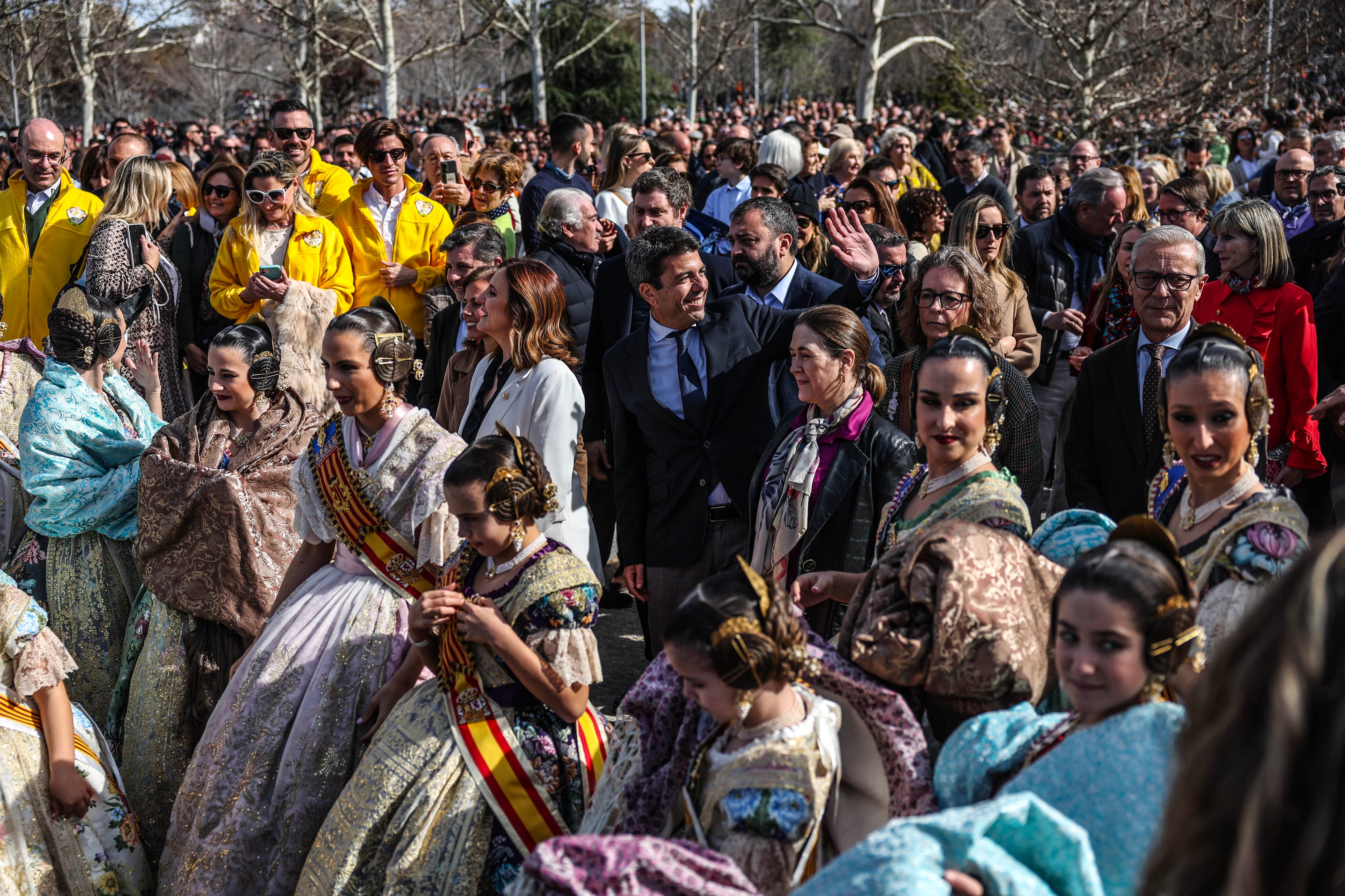 El presidente de la Comunidad Valenciana, Carlos Mazón, entre las falleras, antes de presenciar el espectáculo pirotécnico, celebrado este domingo en Madrid. 