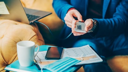 A man working in the office with various technologies.