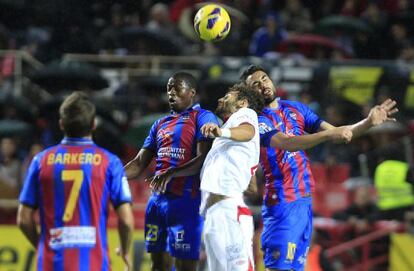 Fazio pelea por el cuero ante dos jugadores del Levante.