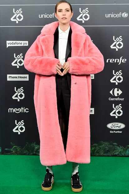 Este maxi abrigo rosa sobre un tuxedo masculino y zapatillas es solo unos de los muchos looks que nos ha regalado este año la cantante y compositora Brisa Fenoy.