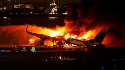 Firefighters work at Haneda International Airport after Japan Airlines' A350 airplane caught on fire, in Tokyo, Japan January 2, 2024. REUTERS/Issei Kato