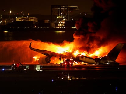 Firefighters work at Haneda International Airport after Japan Airlines' A350 airplane caught on fire,  in Tokyo, Japan January 2, 2024. REUTERS/Issei Kato