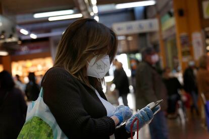 Una mujer protegida con mascarilla y guantes en Sant Cugat, este sábado.