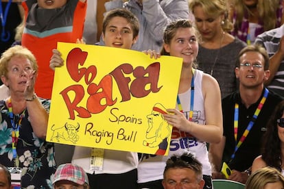 Dos jóvenes animan a Nadal en un partido.