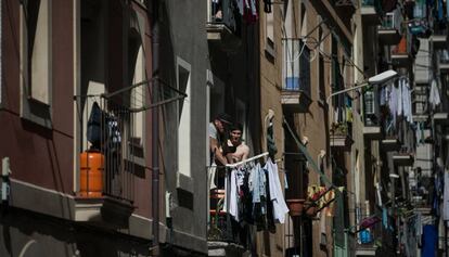 Dos vecinos, en un balcón en el barrio de la Barceloneta.