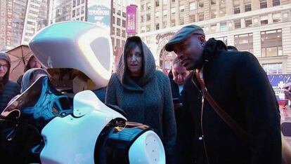 Varias personas interactúan con un robot en Times Square.