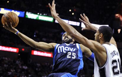 Vince Carter, de los Mavericks, intenta anotar ante Duncan, de los Spurs.