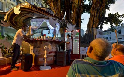 Un grupo de colombianos sigue por televisión la firma de los acuerdos de paz.