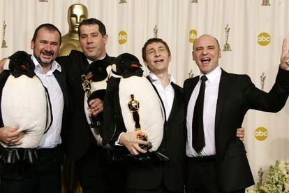 Los franceses Emmanuel Priou, Luc Jacquet, Yves Darondeau, and Christophe Lionel (de izquierda a derecha) posan con el Oscar al mejor largometraje documental. La encargada de presentar este premio ha sido Charlize Theron, candidata a mejor actriz por <i>En tierra de hombres</i>.