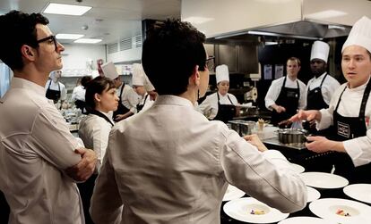 Carme Ruscalleda (de espaldas) y Raül Balam, con su equipo de cocina en el restaurante Moments, en Barcelona.
