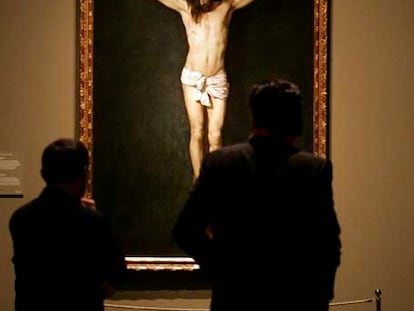 Dos personas observan el <i>Cristo crucificado</i> de Velázquez.