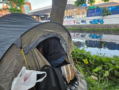 Challou Charriot, who does not want to show his face, tidies up his tent in the Dublin camp