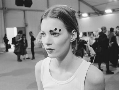 Kate Moss backstage at a fashion show in 1991.