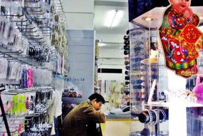 A Chinese storekeeper at the counter of his shop in Palma de Mallorca.