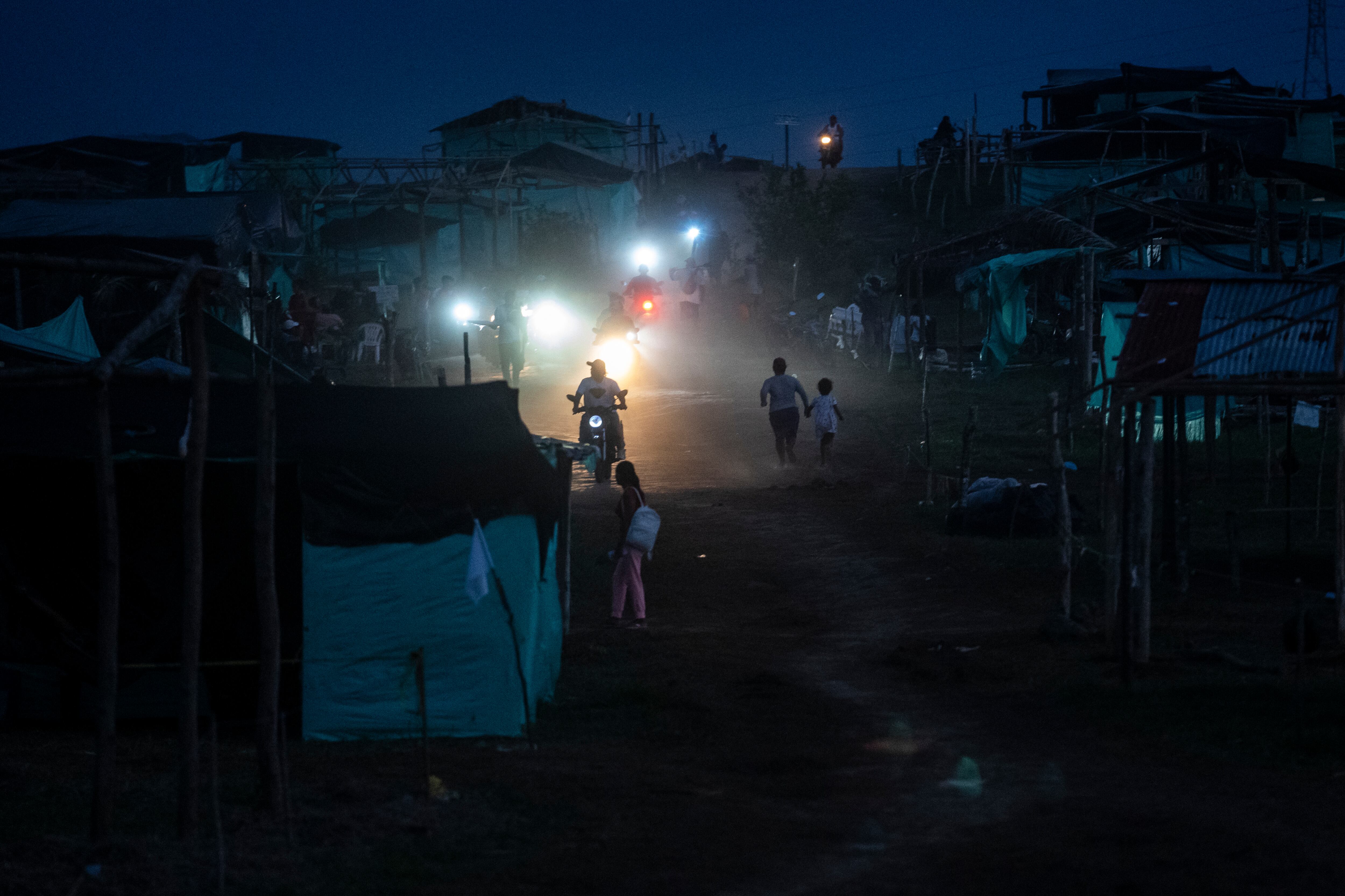 Familias se desplazan por la finca Santa Helena, al anochecer del 6 de mayo.