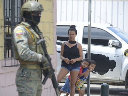 Vecinos de Guayaquil miran a uno de los militares desplegados desde este martes en las calles de la ciudad.