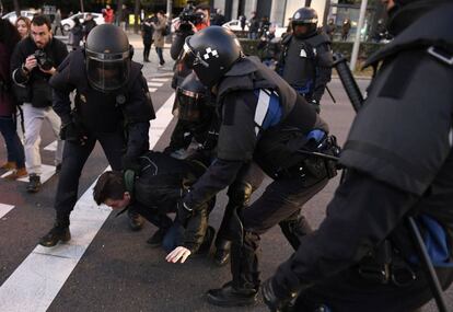 A taxi driver is arrested by police officers during the protest.