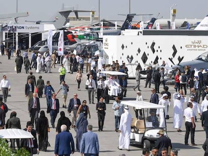 Participantes caminan en la feria de aviación Dubái Airshow.