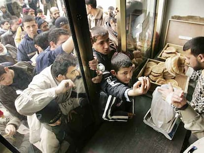 Decenas de palestinos se agolpan en la puerta de una tienda para poder comprar pan, ayer en la ciudad de Gaza.