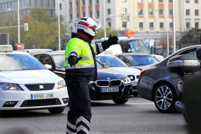 Un policía municipal controla el tráfico en la plaza de Colón.