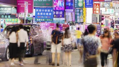 Varias personas pasean por la zona comercial de Mlongkok, en Hong Kong.