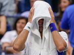 Novak Djokovic, of Serbia, cries as he sits on his bench during a changeover in the third set of the men's singles final against Daniil Medvedev, of Russia, of the US Open tennis championships, Sunday, Sept. 12, 2021, in New York. (AP Photo/John Minchillo)