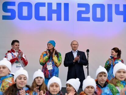 Vladimir Putin e a saltadora Elena Isinbayeva (de gorro azul), em Sochi.