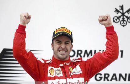 Ferrari Formula One driver Fernando Alonso of Spain celebrates his win during the victory ceremony after the Chinese F1 Grand Prix at the Shanghai International Circuit, April 14, 2013. Alonso roared to victory in the Chinese Formula One Grand Prix on Sunday, making amends for crashing out of the previous race in Malaysia. REUTERS/Aly Song (CHINA  - Tags: SPORT MOTORSPORT F1)  