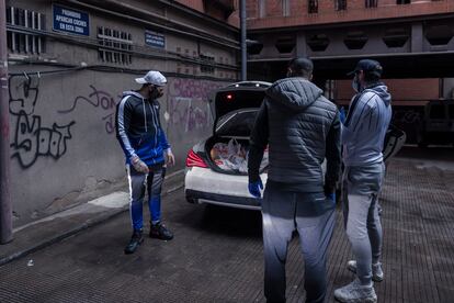 Omar Montes y sus dos colegas, preparados para sacar los alimentos del coche.