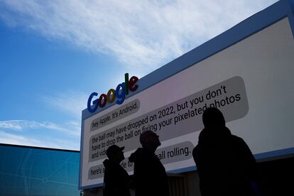 Workers help set up the Google booth at the Las Vegas Convention Center.