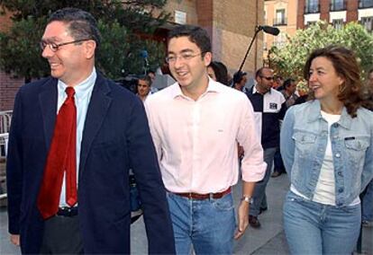 El presidente de la Comunidad de Madrid y candidato del PP a la Alcaldía de la capital, Alberto Ruiz-Gallardón, ha acudido a votar a las 11.00 horas al colegio electoral situado en el Instituto de Educación Secundaria San Mateo, donde ha señalado que "éste es un día para dar las gracias a los madrileños, porque están haciendo de esta jornada electoral una auténtica fiesta de la democracia". En la imagen, el candidato junto a su hijo mayor, Alberto, y su esposa, María del Mar Utrera, a la salida del centro. Alberto, de 20 años, acudía a las urnas por primera vez y ha reconocido la ilusión que sentía al hacerlo por su padre.