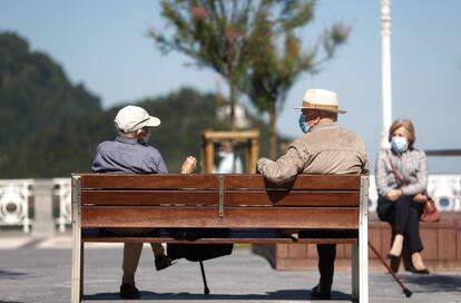 Dos personas conversan en el paseo de la Concha de San Sebastián el 20 de mayo de 2020.