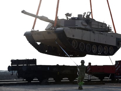 In this file photo taken on February 14, 2017, a US soldier helps to maneuver an Abrams tank.