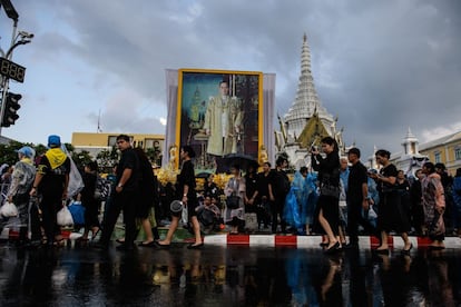 Tailandeses pasa junto a un retrato del rey Bhumibol Adulyadej después del funeral, el 26 de octubre.
