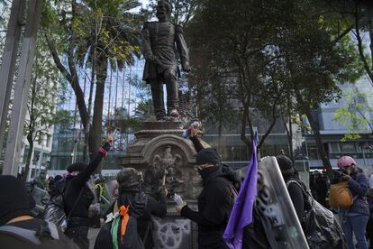 La jornada ha comenzado desde temprano con actos reivindicativos y los monumentos y edificios emblemáticos de la capital vallados para evitar disturbios. En la imagen, el grupo conocido como "bloque negro" pinta parte del mobiliario urbano del Paseo de la Reforma.