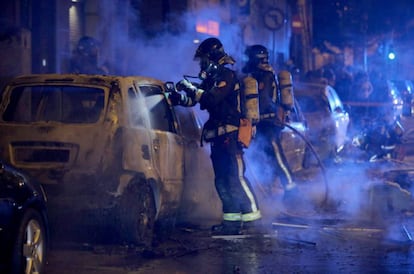 Firefighters put out fires set by protesters in Barcelona.